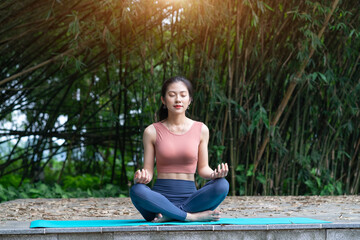 Young Asian woman doing exercise in the park