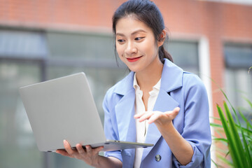 Young Asian woman working outside