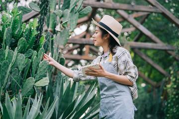 Young Asian woman takes care of the garden