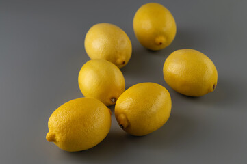 group of yellow ripe lemon fruits on gray background