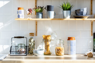 Kitchen shelf with various spices and pasta