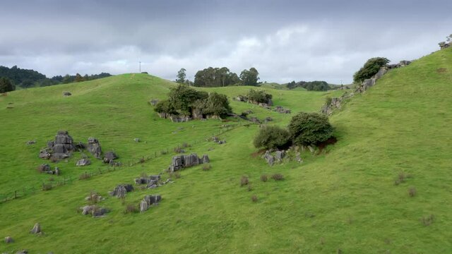 Aerial: Limestone outcrops and rugged farm landscape. Location used in the Lord of the Rings movie.  Waitanguru, Waikato, New Zealand