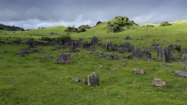 Aerial: Limestone outcrops and rugged farm landscape. Location used in the Lord of the Rings movie.  Waitanguru, Waikato, New Zealand