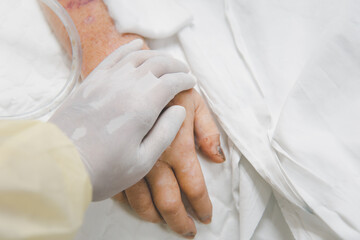 Fototapeta na wymiar Patient in the hospital and holding a hand