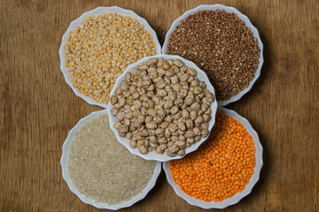 Various cereals on a wooden background. The concept of wholesome food. Vegetarian food