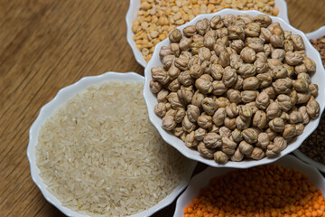 Various cereals on a wooden background. The concept of wholesome food. Vegetarian food