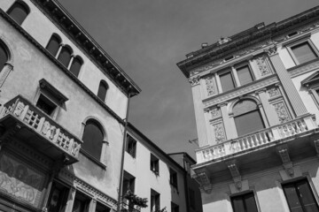 Urban background. View from below on the historic Art Nouveau buildings of the city of Padua. Beautiful historic buildings against the sky. Black and white image.