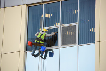 Man Cleaning windows on a Office Building
