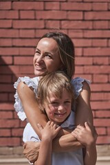 Mother and two kids walking in city center