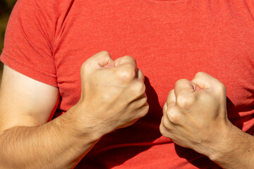 The man shows his fists and prepares for a fight and protection from robbers