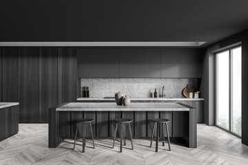 Dark grey breakfast bar with kitchen cabinet on background