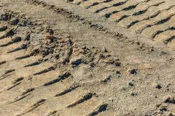 Impints of the truck tires on sand near quarry. Earthworks, offroad