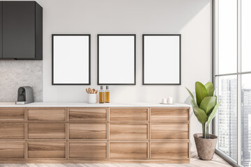 Wooden kitchen interior with kitchenware near window, three mock up posters