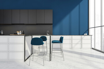 Stylish kitchen interior with table and chairs on white concrete floor