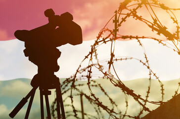 Double exposure - camera, barbed wire and flag Hungary