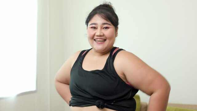 Happy woman plus size with sportswear. Body positive plus size female work out  lives happily and is proud of herself.