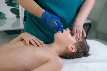 Session of craniosacral therapy, cure of teen boy's jaws by a doctor therapist. Craniosacral...
