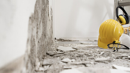 house renovation concept, wall in demolition with plaster rubble and protective construction work...