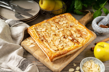 Homemade pie with apples, cinnamon and almonds from puff pastry