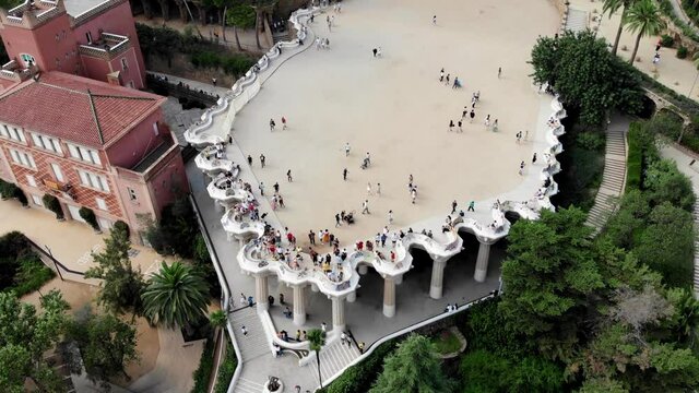 Drone shot Park Guell in Barcelona. Panoramic view of the city of Barcelona. Spain from drone. Park at the top of Barcelona. Drone view of gardens and residential areas in Spain.
