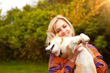 Portrait of a woman with a dog corgi breed.