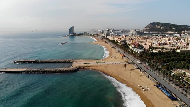 Drone shot Barcelona. Drone view of a vibrant swimming and sunbathing beach in Barcelona. People are relaxing on the beach. Panoramic view of the city of Barcelona. Spain from drone.