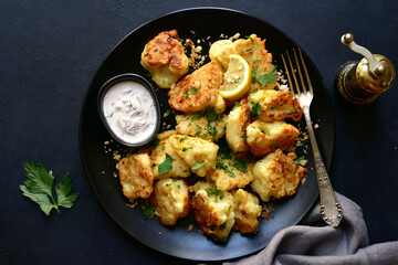 Roasted  spicy cauliflower with cheese and garlic crumbs. Top view with copy space.