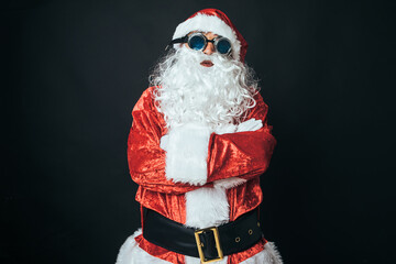 Man dressed as Santa Claus with Victorian style welder goggles, on black background. Concept of Christmas, Santa Claus, gifts, celebration.