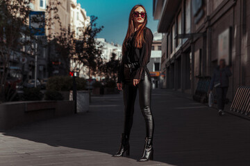 Fototapeta na wymiar sexy lady in leather suit stands in the city