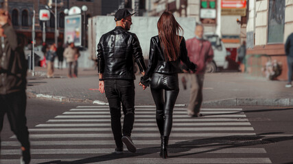 beautiful couple walks across the road