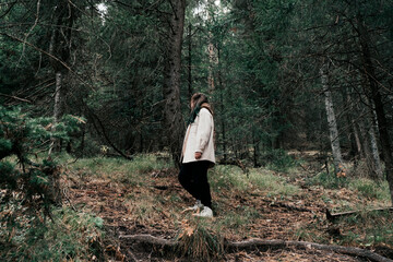 A young woman in a green forest.