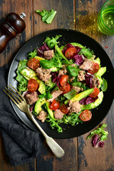 Tuna salad with tomatoes and avocado. Top view with copy space.