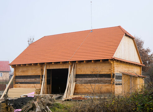 Jobsite of a renewed old wooden barn on a foggy late autumn day.