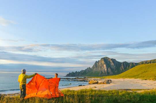 couple camping with tent near seaside in Norway