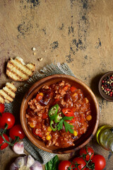 Traditional mexican dish chili con carne - spicy minced meat with vegetables in tomato sauce. Top...