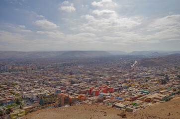 Panoramic landscape scenic view from hilltop viewing point outlook Morro de Arica over downtown and...