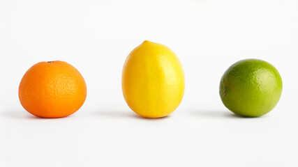 Mandarin, lemon and lime on a white background.