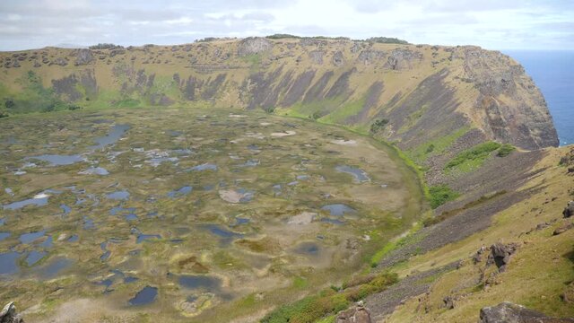 A large volcanic crater on Easter Island. Rano Kau crater. Orongo Crater from ridge in Easter Island, Chile. A crater on exotic volcanic island, Rapa Nui.