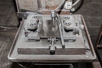 Obraz na płótnie Canvas Process and system, equipment and tool for metalworking with fixing mechanisms for drilling iron with a tube for cooling water in the workshop of an industrial plant
