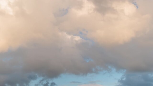 Timelapse - fast moving dramatic clouds against blue sky at sunset. Nature, freedom, time lapse concept
