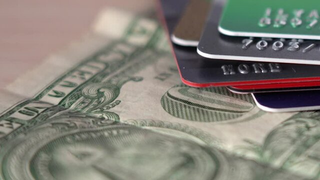 Putting Plastic Cards On Top Of Dollar Bill