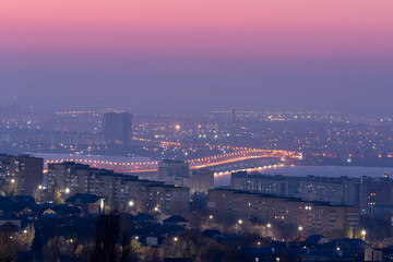 pink dawn dusk sky above big city. sunrise early morning cityscape light