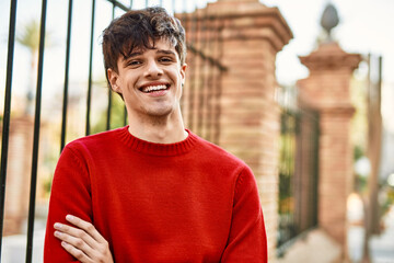 Fototapeta premium Young hispanic man smiling happy standing at the city