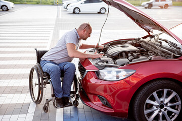 person with a physical disability check engine his car at parking
