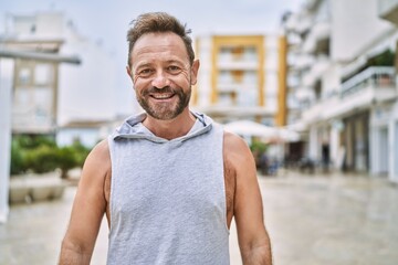 Fototapeta premium Middle age man smiling confident at the city