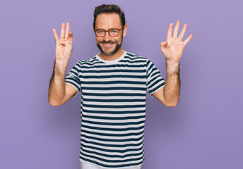 Fototapeta premium Middle age man wearing casual clothes and glasses showing and pointing up with fingers number nine while smiling confident and happy.