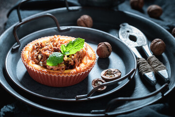 Homemade and fresh walnut cheesecake made caramel and nuts.