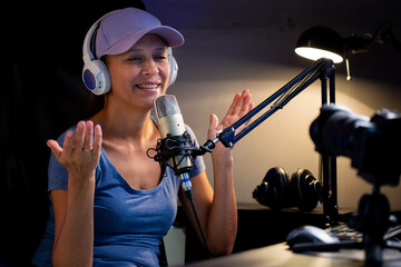 Beautiful Woman In A Cap And White Headphones Leads A Live Stream