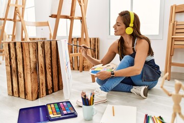 Young hispanic artist woman smiling happy drawing at art studio.