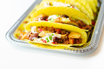 Mexican tacos shells with chicken and red kidney beans, onion,  red and green peppers, and salsa sauce